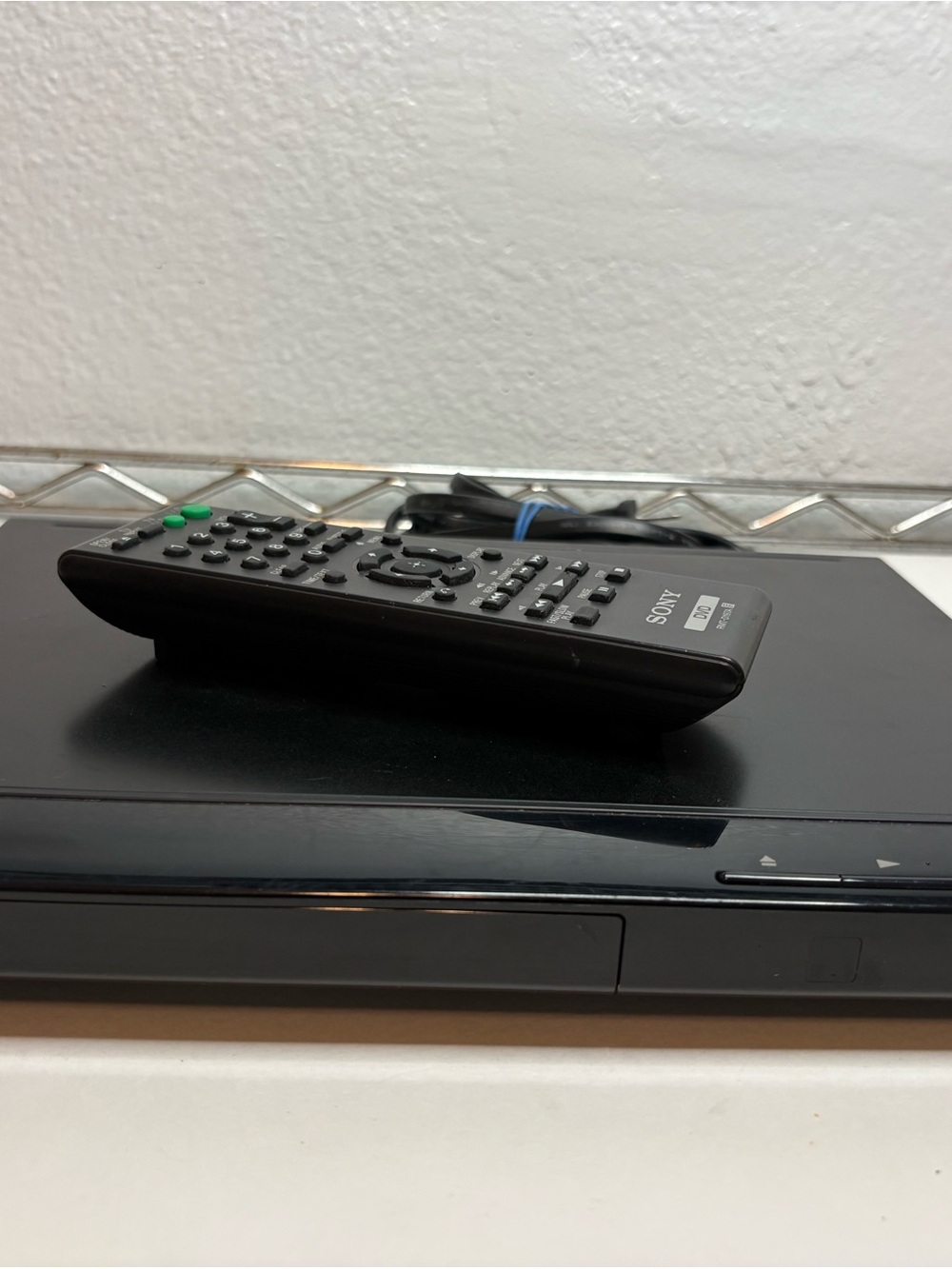 Sony Black DVD Player with Black Remote and Green Buttons